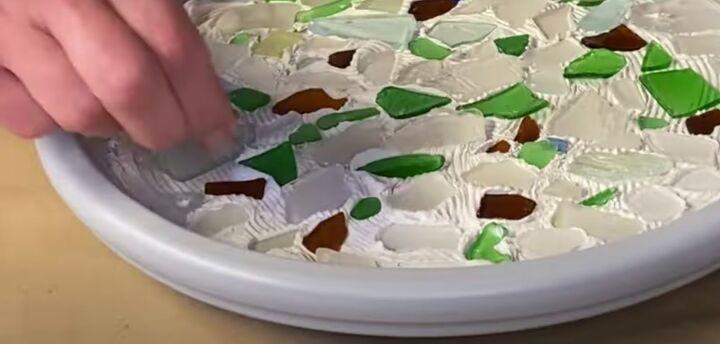 this cute diy birdbath is guaranteed to attract a few feathered friend, Pushing sea glass into wet tile adhesive