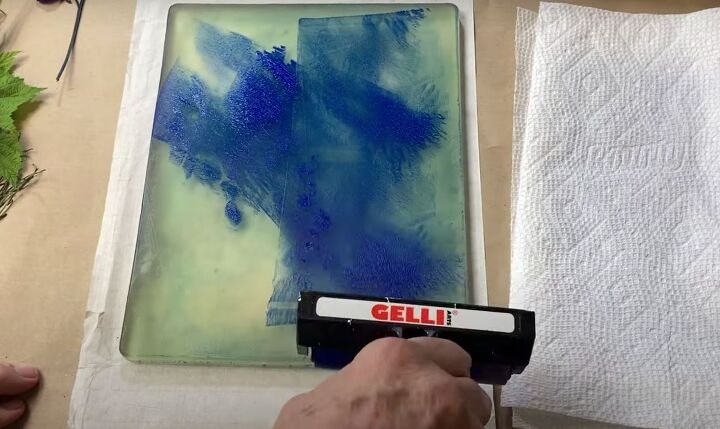the surprisingly easy way to make your own botanical prints, Using a brayer to spread the blue paint over the gel press printing plate