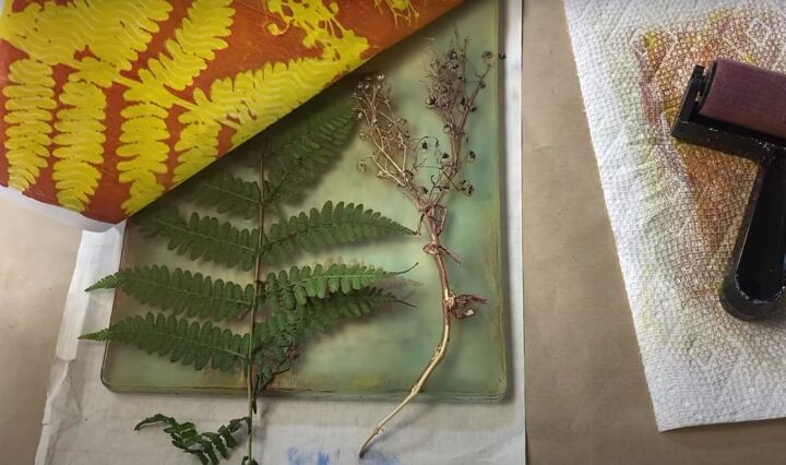 the surprisingly easy way to make your own botanical prints, Removing paper from the gel press printing plate with greenery and plants