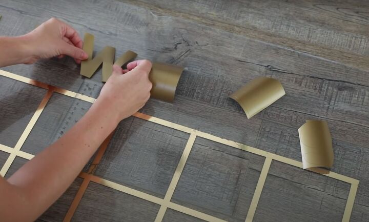 get organized how to make a stunning diy acrylic calender, Sticking vinyl letters to the board for the days of the week