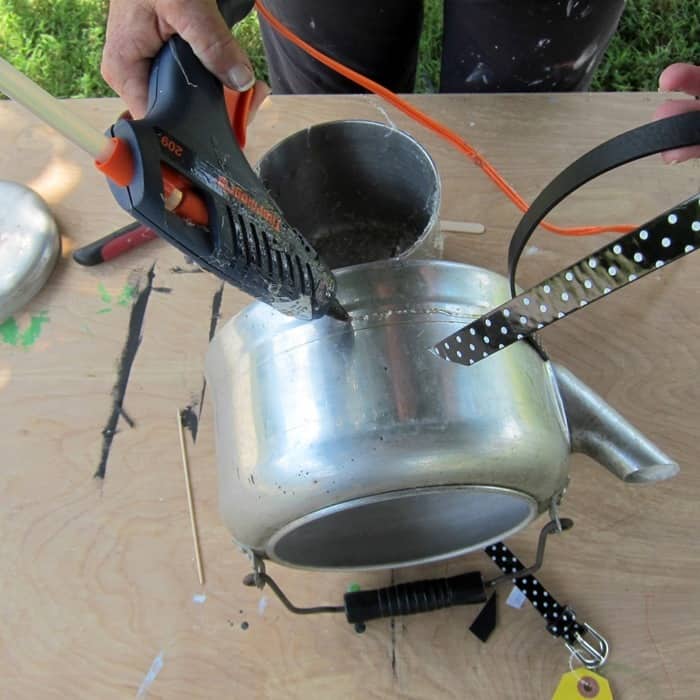 use an old tea kettle as a flower pot