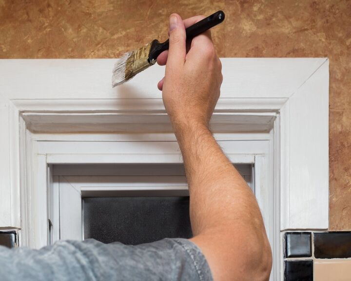 how to trim out a window for a flawless finish, person painting window trim white