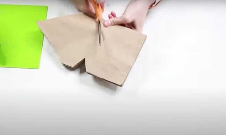 how to make this beautiful rustic paper bag snowflake craft, Cutting triangle shapes on the sides of the paper bag snowflake