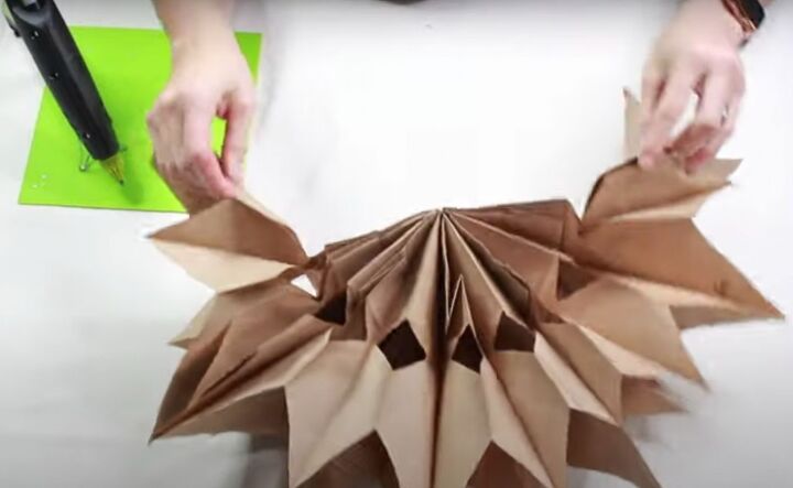 how to make this beautiful rustic paper bag snowflake craft, Fanning out the showflake by pulling the two sides together