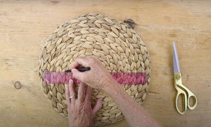 here s how to make gorgeous boho rainbow wall decor, Drawing a line in the center of a woven placemat