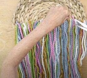 here s how to make gorgeous boho rainbow wall decor, Cutting the excess yarn with scissors