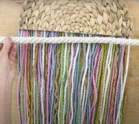 here s how to make gorgeous boho rainbow wall decor, Measuring cotton rope to the width of the placemat