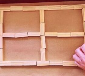 She glues together a set of toy blocks for this brilliant & beautiful way to decorate her wall