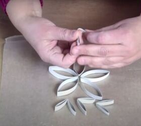 how to make festive glitter toilet paper roll snowflakes, Folding a few of the cardboard strips
