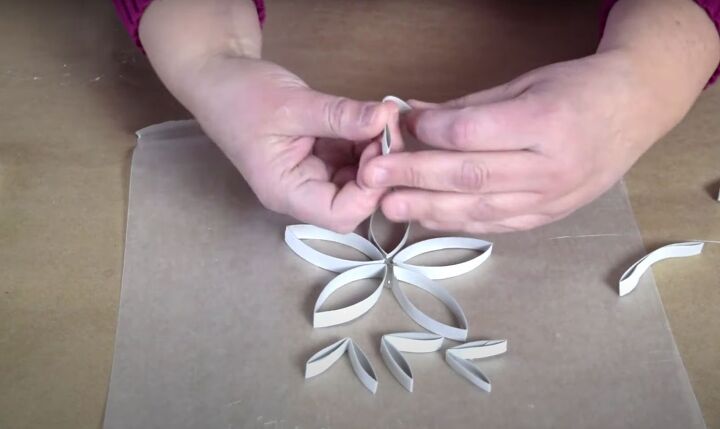 how to make festive glitter toilet paper roll snowflakes, Folding a few of the cardboard strips