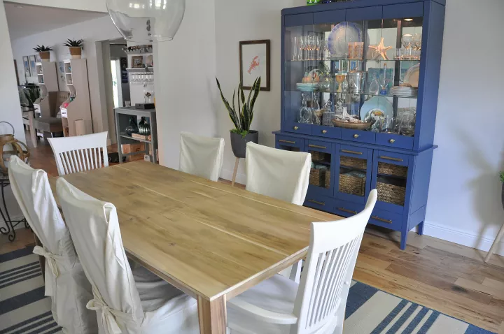 how to refinish a dining table, dining room with wood table white chairs and blue hutch
