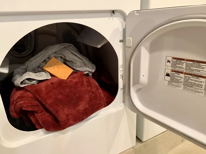 the top 7 best dryers of 2022, open dryer filled with clothes Photo via Rebecca RestyledHomes