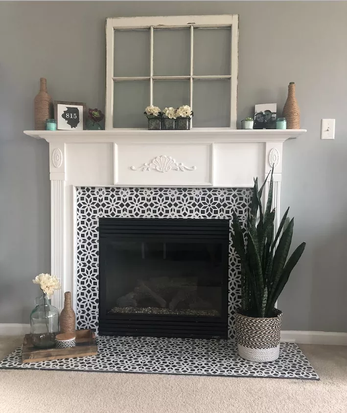 best electric fireplaces, electric fireplace with faux tile border and white mantel Photo via Ashleigh Sommer