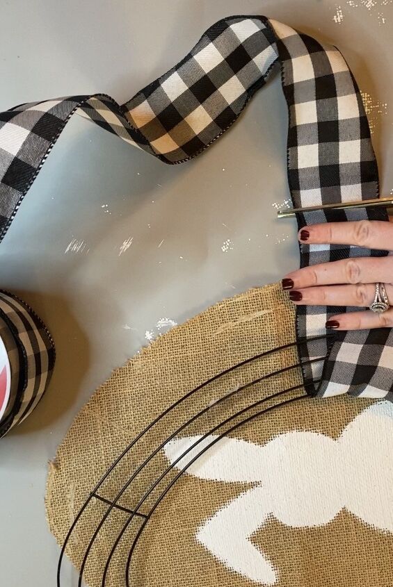photo of megan wrapping the egg-shaped wireframe wreath in black gingham-print fabric