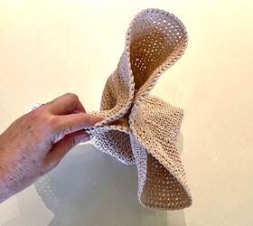 She folds up a floppy hat and ends up with clever bathroom organization