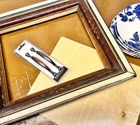 This is such a simple and beautiful way to use a picture frame, 2 cabinet pulls, and a few old plates