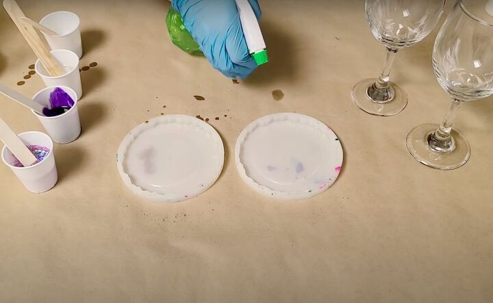 9 easy steps to gorgeous geode resin wine glasses, Spraying the resin in the mold with isopropyl alcohol to remove air bubbles