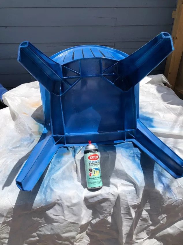 the best spray paints for plastic for 2022, blue spray painted chair on white sheet photo via Ruth