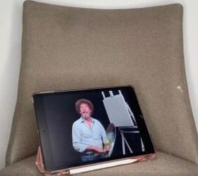 Instead of using a canvas, she grabs an old chair for this crazy cool Bob Ross hack