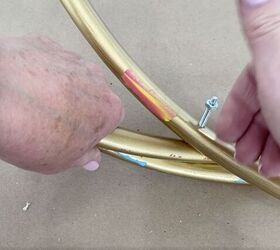 how to make a gorgeous outdoor hula hoop chandelier, Adding a nut to the end of the screw