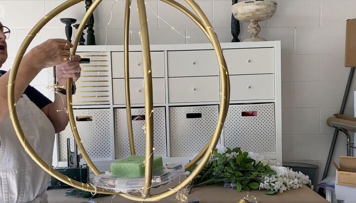 how to make a gorgeous outdoor hula hoop chandelier, Wrapping fairy lights around the hula hoops
