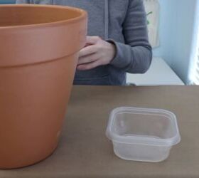 how to make a stunning front porch planter idea for spring, A plant pot and plastic dish with water