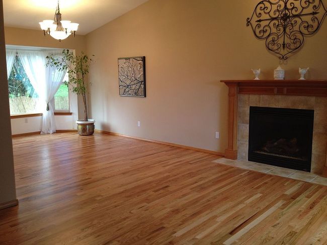 how to restore hardwood floors without sanding yes it s possible, living room with refinished hardwood floors and fireplace
