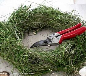 diy bird s nest wreath with twigs and flowers, A wreath made of hay makes a great base for a bird s nest wreath