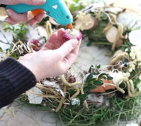 diy bird s nest wreath with twigs and flowers, Attaching Strawflowers to the wreath with hot glue