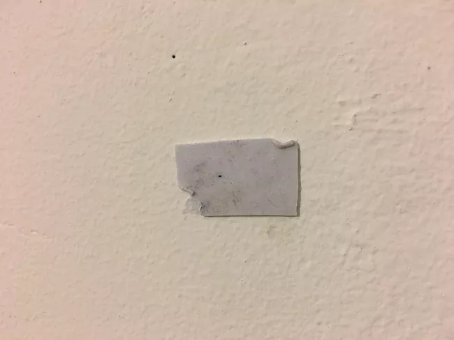 how to remove double sided tape, piece of double sided tape stuck to wall