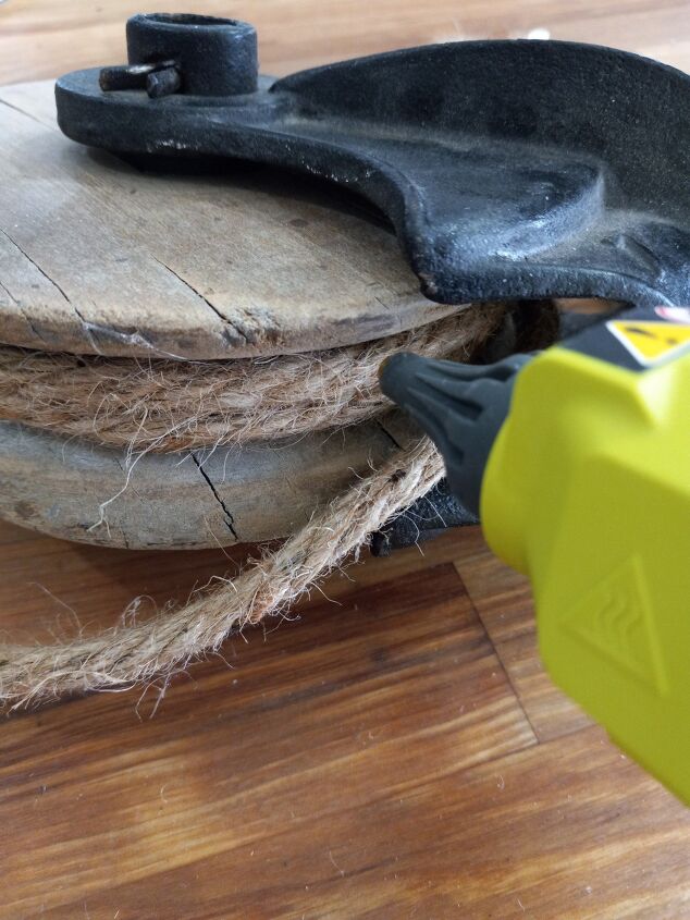 how to make a cute farmhouse pulley hanging bucket planter, Attaching the rope to the pulley