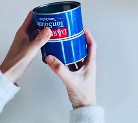 She stacks up 2 tuna cans and grabs an old placemat for this pretty storage upgrade