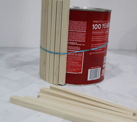 Wrap wood dowels around a hot chocolate can to copy this $20 countertop hack