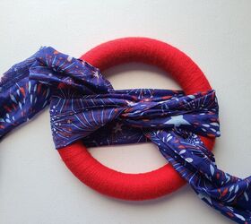 Tie a scarf around a wreath form for the easiest, coolest, $3 door idea