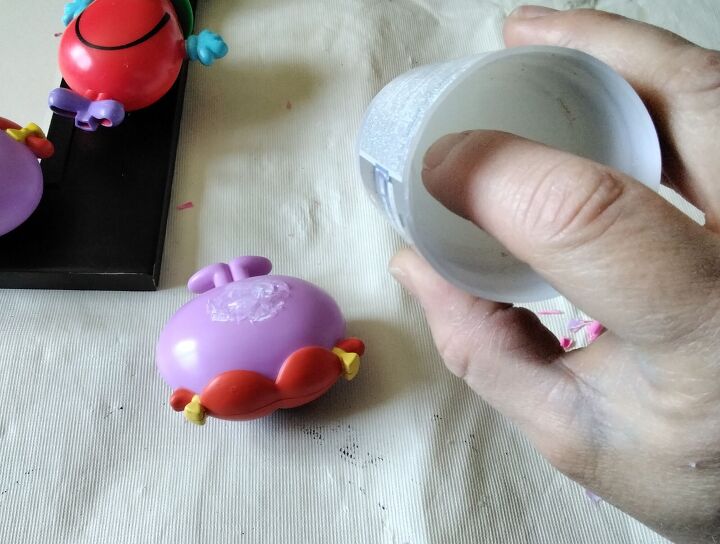 creating a children s styled mirror using upcycled toys, Push Up Glue Release