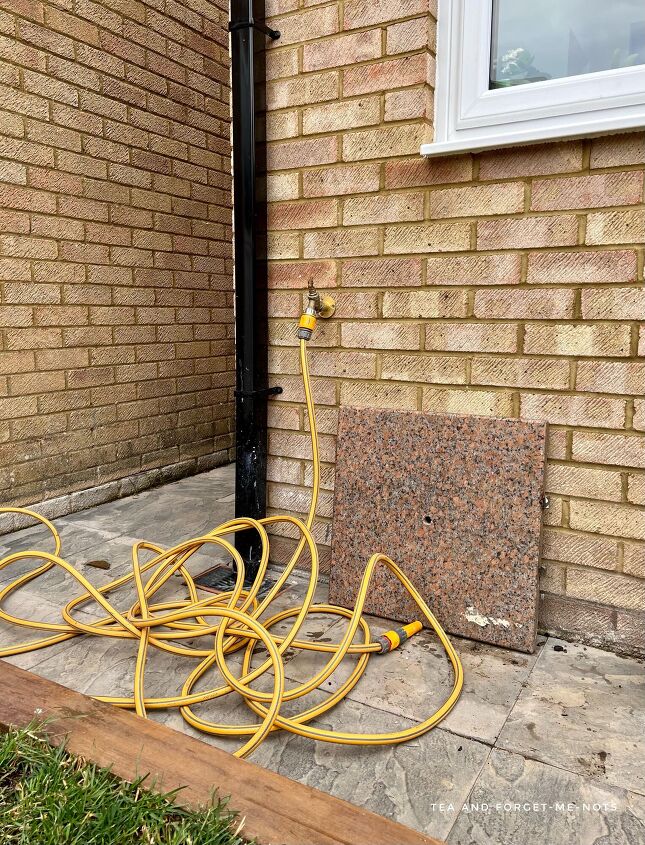 an unusual way to hide a garden hose