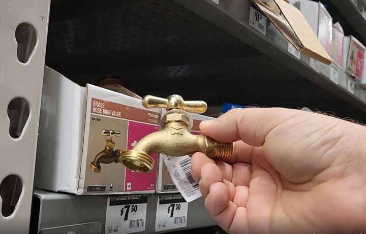 mesmerize your guests with this fancy floating fountain diy, Man holding brass outdoor spigot