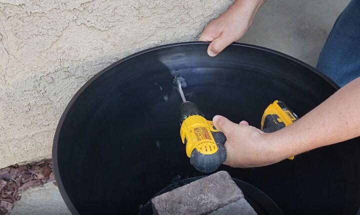 mesmerize your guests with this fancy floating fountain diy, Drilling a hole in the side of the planter