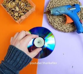 She places a tealight in the center of an old CD for this unexpected and beautiful hack