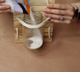 how to make a nautical mason jar lamp in 6 easy steps, Adding white sand to the jar