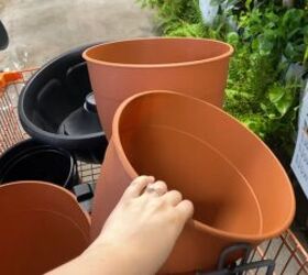 He stacks 4 plastic planters on his porch for this beautiful, year-round idea