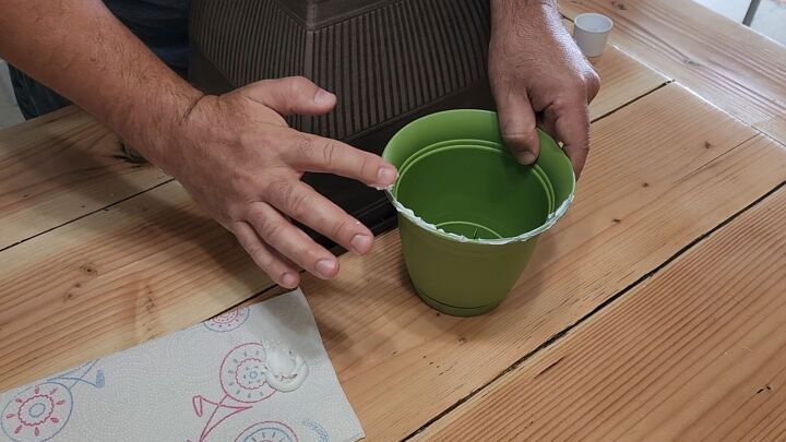 how to turn plastic planters into a beautiful diy urn planter, Attach the smaller pots to the base pot using glue