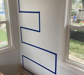 She runs a line of painter's tape down her wall for this unique & beautiful storage idea