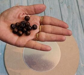 She grabs a handful of wooden beads for chic boho-inspired decor