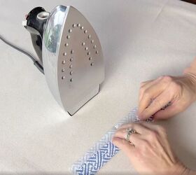 3 quick and easy decorative taper candle projects, Preparing to iron a patterned paper napkin onto a taper candle