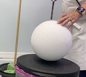7 simple steps to make this festive diy christmas topiary, Drilling a pilot hole into a Styrofoam ball