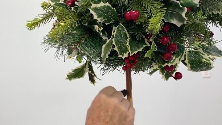 7 simple steps to make this festive diy christmas topiary, Painting the wooden stick of the DIY Christmas topiary