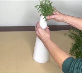 3 easy citrus dcor ideas to upgrade your home for the holidays, Attaching rosemary stalks to a Styrofoam cone