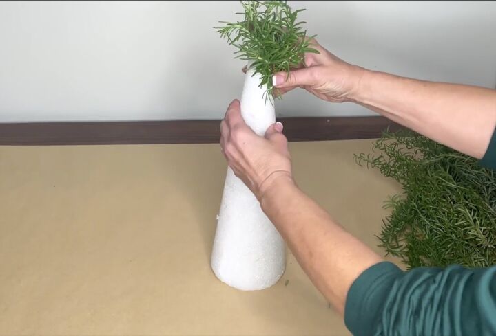 3 easy citrus dcor ideas to upgrade your home for the holidays, Attaching rosemary stalks to a Styrofoam cone
