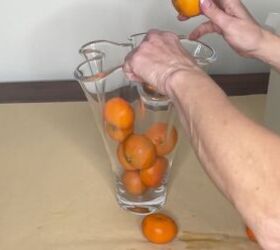 3 easy citrus dcor ideas to upgrade your home for the holidays, Adding oranges to a clear glass vase